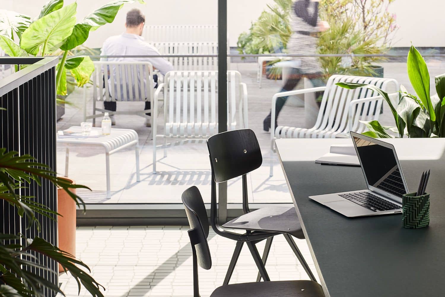 Bright modern workspace with an indoor-outdoor feel and sleek office furniture.
